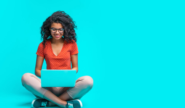 woman on computer blue background