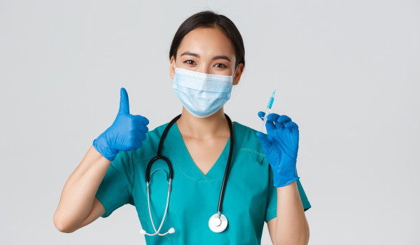 covid vaccine doctor in scrubs