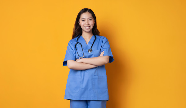 doc in blue scrubs smiling