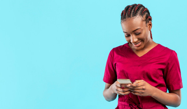 nurse holding phone burgundy scrubs