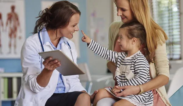 Image of Doctor talking with mum and daughter