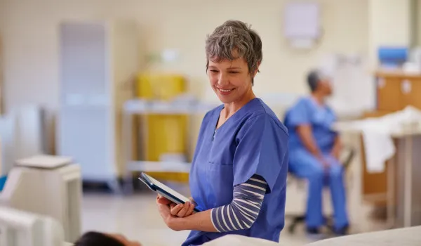 Image of nurse with patient smiling