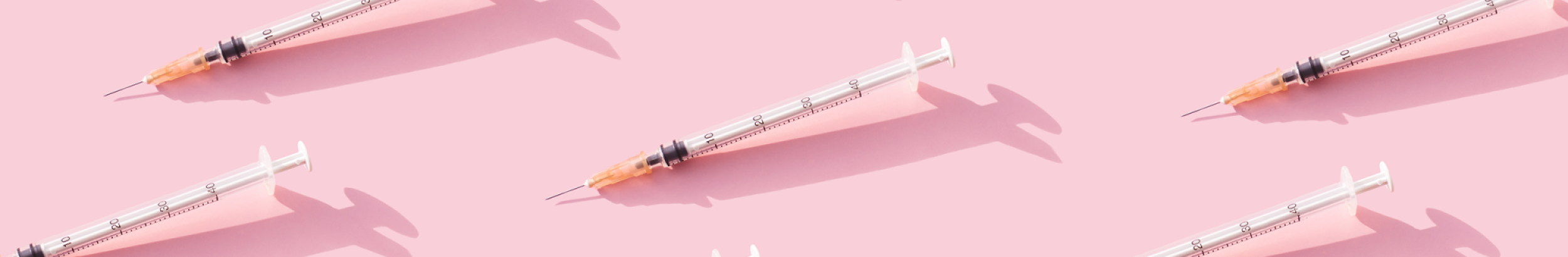 Immunisation needles pink background