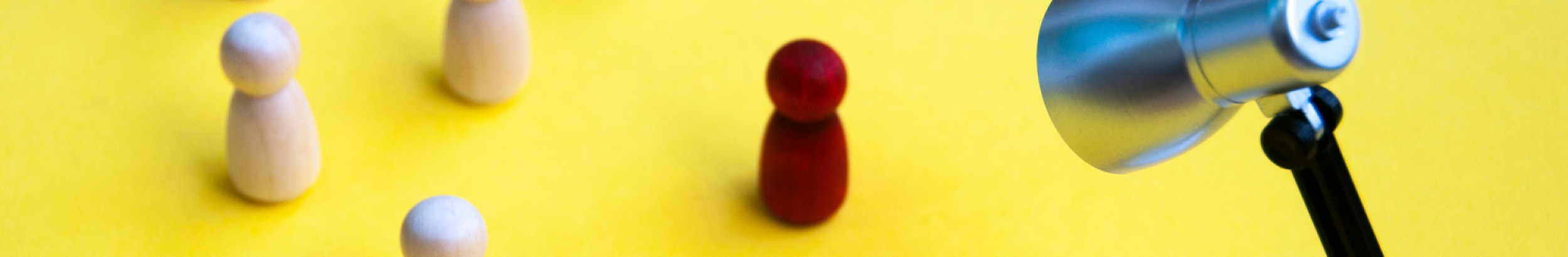 spotlight on red wooden figure