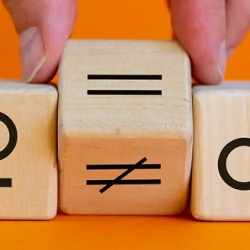 A hand placing an 'equals' symbol between female and male symbols