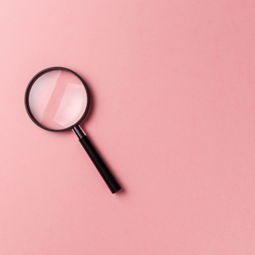 magnifying glass on pink background