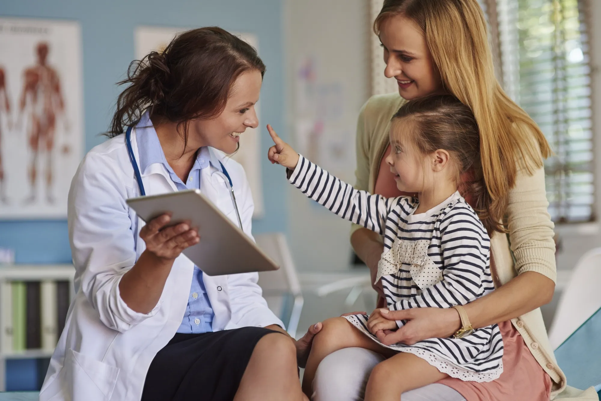 Image of Doctor talking with mum and daughter