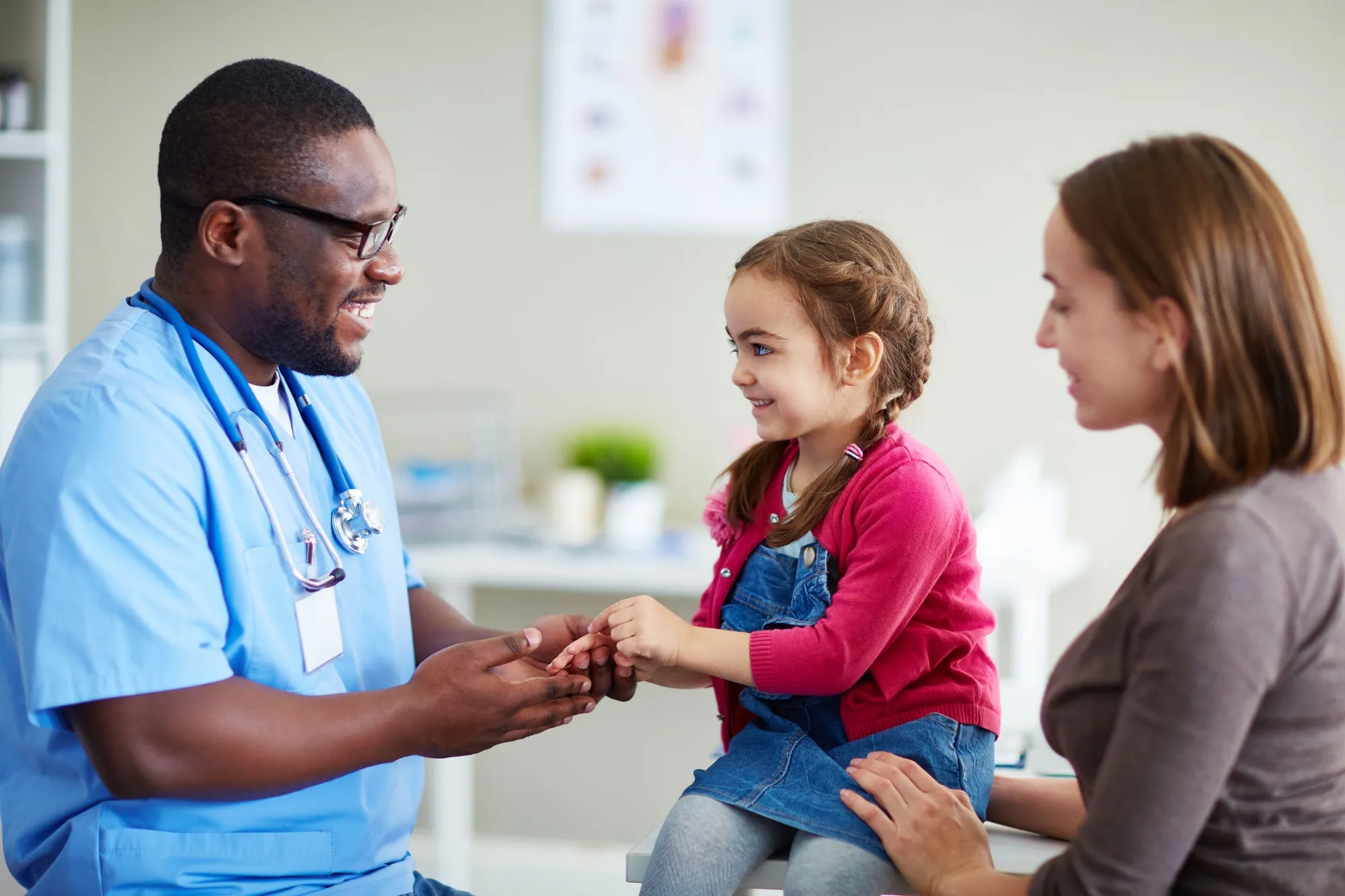 Image of Doctor with mum and daughter