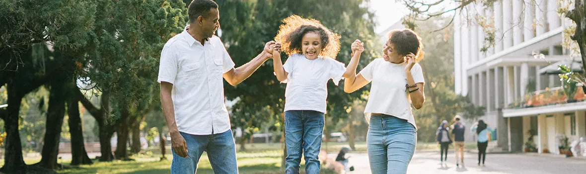 Image of Family walking holding hands